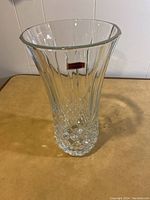 Clear 12 inch Waterford crystal vase showing diamond cuts at base and vertical cuts above with Waterford label.