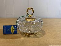Clear crystal dish with cut pattern and Claddagh top handle with 22ct gold finish, showing label and blue Killarney tag.