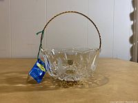 Front angled view showing crystal basket and gold handle with attached tags
