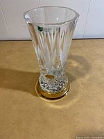 Front view of clear crystal vase with hand cut leaf pattern and gold finished base, showing Killarney Crystal Ireland label and hand cut guarantee sticker.