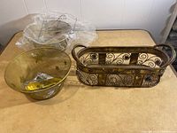 Three baskets shown together on beige surface against white paneled wall.