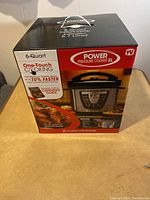 Box front showing Power Pressure Cooker XL 6-Quart, one-touch cooking feature, cooking up to 70% faster, canning guide included, Fusion Life Brands logo.