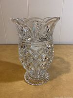 Crystal vase shaped like a pineapple with detailed cut pattern and flared rim.
