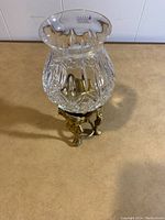 Top angled view of Royal Irish Crystal candle globe with diamond cut pattern and brass base showing detailed design.