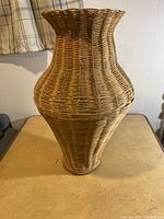 Front view of the large wicker vase showing shape and weave pattern in natural light.