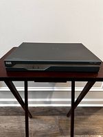 Front-angled view of the Cisco 1841 router showing front panel and branding.