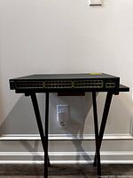 Front-facing view of the Cisco Catalyst switch showing 48 Ethernet ports and status LEDs.