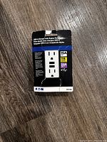 Boxed Eaton TR7765 USB-A charger with duplex receptacle in unopened packaging showing product image and electrical specifications.