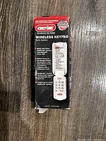 Photo of the boxed Genie Wireless Keypad branding and product details, showing the original packaging with some damage.