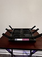 Top-angle view of the router showing all six antennas extended and LED indicator panel visible on front center.