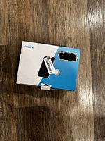 Closed Reolink branded box showing the product image and logo on a wooden surface.