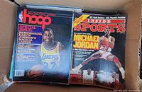 Box open showing NBA Hoop magazine featuring Magic Johnson and Inside Sports magazine with Michael Jordan on covers.