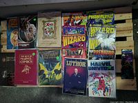 Top-down view of all books, magazines and card packs arranged on wooden surface