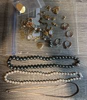 Full overview of the jewelry collection showing a variety of rings, chains, pearl necklaces, and lockets.