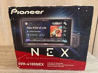 Front view of the original box showing Pioneer NEX branding and model AVH-4100NEX with a touchscreen display image and remote control picture.