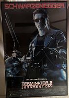Full view of the Terminator 2 framed movie poster showing Arnold Schwarzenegger on a motorcycle.