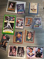 Top down image showing multiple collected trading cards including baseball, basketball, football, and NASCAR cards laid out on a flat surface.