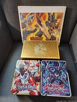 Three storage containers and binder cover art