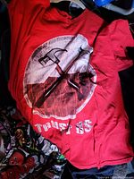 Red Roger Waters The Wall Live Tour 2010 concert t-shirt front with crossed hammers graphic and 'TRUST US' text.