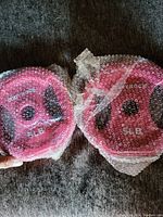 Photo of two pink 5 lb aerobic weights wrapped in bubble wrap.