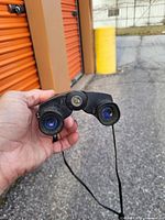 Close-up of front view showing the blue tinted lenses and central knob with Bushwell logo.