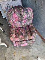 Kids recliner chair from front, showing pink and brown camouflage upholstery and padded design