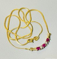 Necklace laid out showing central gemstones and chain