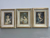 Front view showing all three framed antique art prints laid out side by side, depicting women in period dress.
