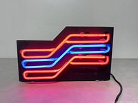 Front view illuminated showing red and blue neon tubes and overall design.