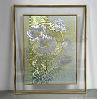 Front view of modernist floral wall art with silver and gold metallic flower design framed in thin gold metal frame.