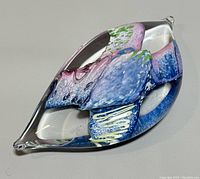 Top angle photo showing the clear outer glass and the multicolored internal design with a mix of pink, blue, green, and yellow elements.