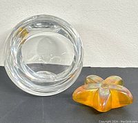 View of bottom of clear glass bowl showing round base and etched Orrefors signature inside