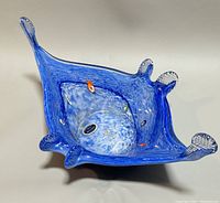 Top view showing blue freeform shape with millefiori details and original Murano sticker inside bowl.