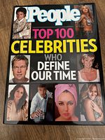 Front cover of the 2011 People Top 100 Celebrities hardcover book featuring celebrity portraits and bold title lettering.