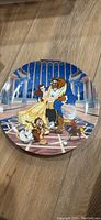 Front photo of the collectors plate showing Beauty and the Beast characters dancing in a ballroom.