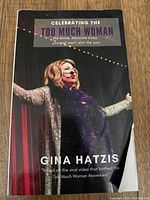 Front cover of 'Celebrating the Too Much Woman' by Gina Hatzis depicting a woman onstage.