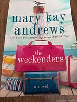 Soft cover novel 'The Weekenders' by Mary Kay Andrews with beach-themed cover art showing colorful bags and a seagull.