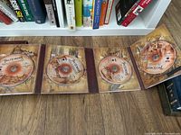 Inside view of The Two Towers Extended Edition DVD box set showing four DVDs with map artwork background.