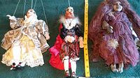 Top view of the three marionette puppets laid out with measuring tape showing size.