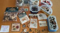 Full collection of beads, charms, metal rings and dreamcatcher-related items laid out on table
