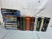 Full view of all Blu-ray and DVD movies arranged in two rows including franchises like Star Wars, Green Lantern, and The Lord of the Rings boxed sets.