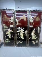 Full view of the 3 Chinese wall art panels, showing figures and mountain scenery on red backgrounds with gold patterned frames.