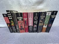 Front view of 10 Stephen King paperback novels, showing spines with titles including The Stand, Cell, Dark Tower series, and more.
