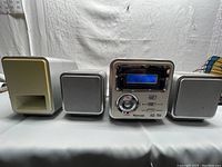 Full stereo system setup showing main unit, subwoofer, and two satellite speakers on white backdrop