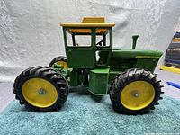Right side profile of the tractor showing articulation joint and tandem wheels