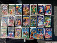 Top-down photo of 20 Walt Disney VHS movies arranged in 4 rows of 5.