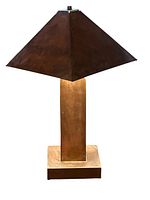 Full view of vintage patinated copper metal table lamp with pyramid shade.