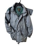 Full view of the Eddie Bauer men's goose down jacket in gray with multiple pockets and zip-off hood.