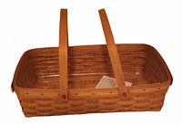 View of the empty handwoven medium rectangular Longaberger gathering basket with two wooden handles, showing the woven wood structure and clean wood finish.