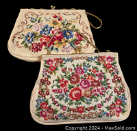 Two needlepoint purses with floral needlepoint pattern, larger shown behind smaller purse on black background